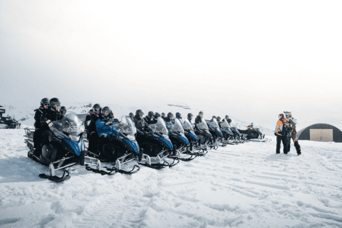 Snowmobiles lined up and ready to go