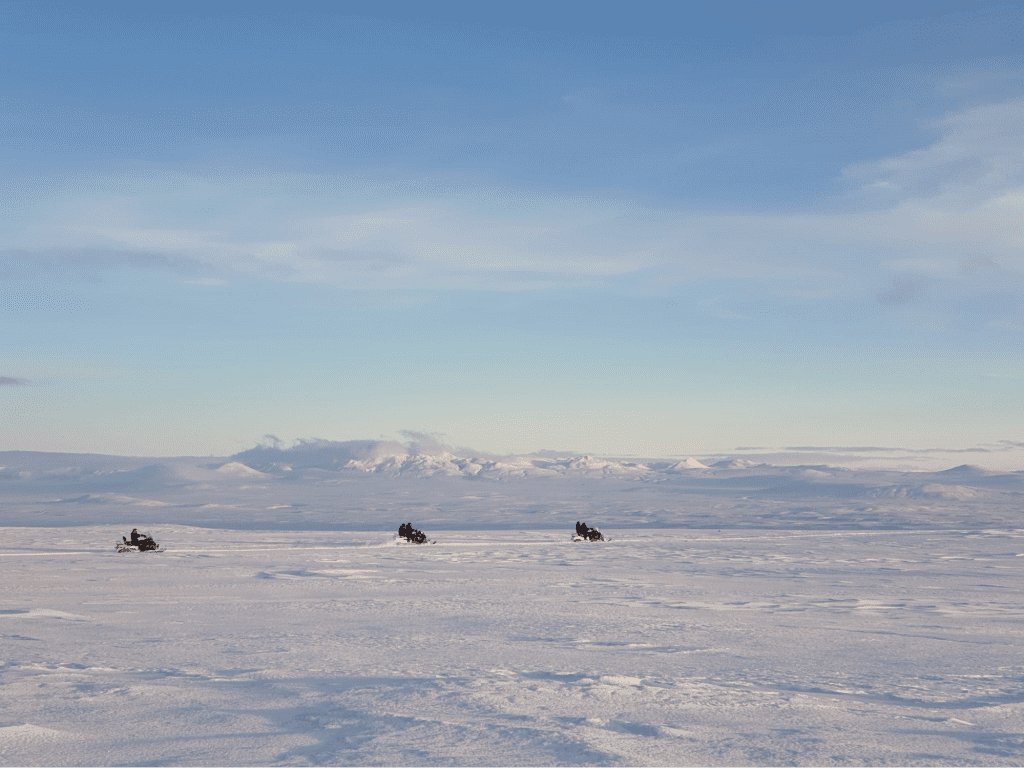Snowmobiles driving on glacier