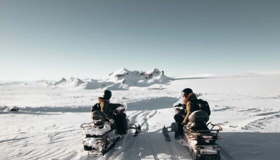 2 snowmobiles on a glacier